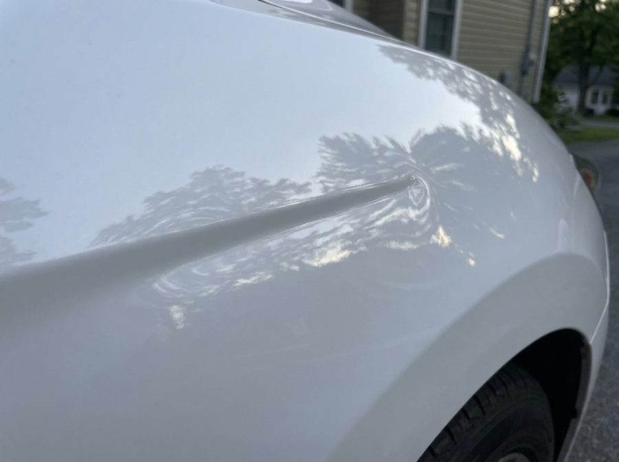 The same white fender smooth after PDR